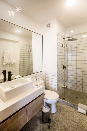 A modern bathroom with a large mirror, white sink, and toilet. - Wynwood Pedro Bustamante in Barranco (Lima)