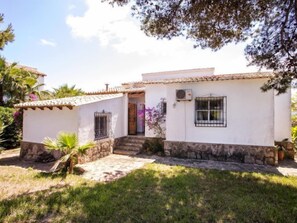 A two-story house with a tiled roof, a stone foundation, and a small front porch. - Casa Moser by Interhome (Jávea)