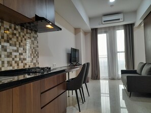 One-Bedroom Apartment | Living area | 40-inch LED TV with satellite channels, TV - Kawana Golf Residence (Cikarang)