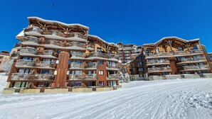 A multi-story wooden building with balconies, likely a hotel or resort, in a snowy environment. - Beautiful 2-room apartment for 4 in Avoriaz, Southeast balcony (Avoriaz)