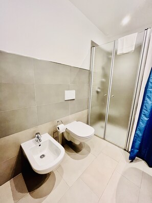 A bathroom with a sink, toilet, and glass shower enclosure. - Bougainvillea Residence (Torri del Benaco)