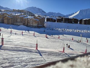A ski resort with multiple wooden lodges and a ski slope.