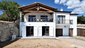 A two-story building with a balcony, a checkered floor, and a stone wall. - Holiday Home 'Ami' with Sea View, Private Terrace and Shared Garden (Arzana)