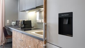 A modern kitchen with a built-in water dispenser, a kettle, a coffee maker, and a microwave. - Superior Mονόχωρο Διαμέρισμα, Psiri Vibes (Athens)