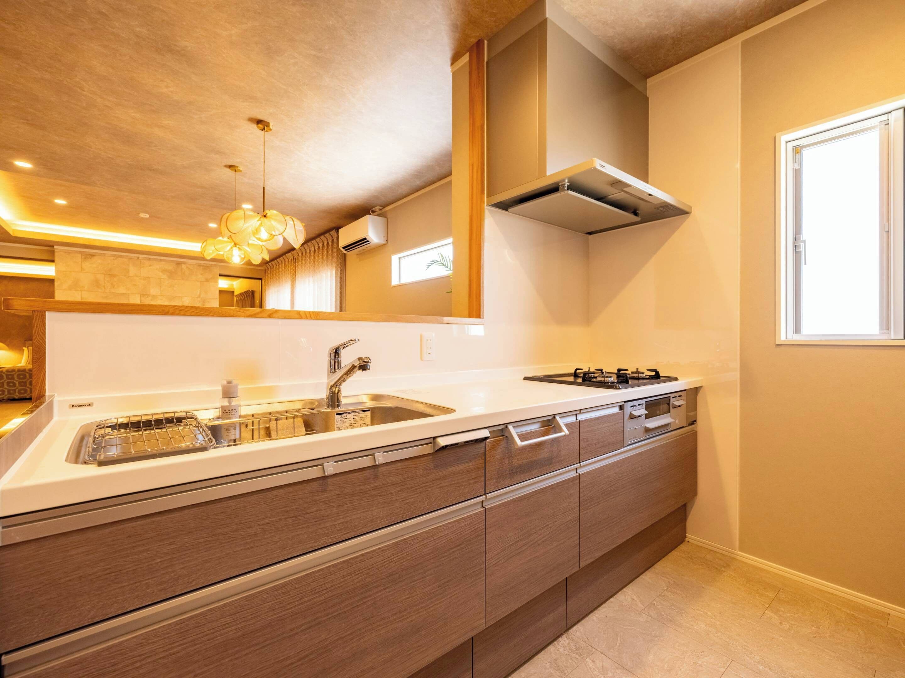 A modern kitchen with a built-in stove, sink, and wooden cabinets.