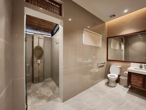 A modern bathroom with a glass-enclosed shower, a toilet, and a sink. - COSTA CELINE BEACH RESORT (Cateel)