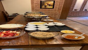 A buffet table with various dishes and bowls of food. - MeroStay 220 Hotel CBR (Bhaktapur)