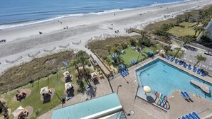 A resort with a pool, beach access, and a view of the ocean.