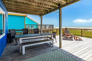 Enjoy dining or relaxing on the deck with a view of the beach.