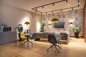 A modern kitchen with a dining area, wooden flooring, and pendant lighting. - ipartment Berlin Mitte @HOME by Best Western (Berlin)