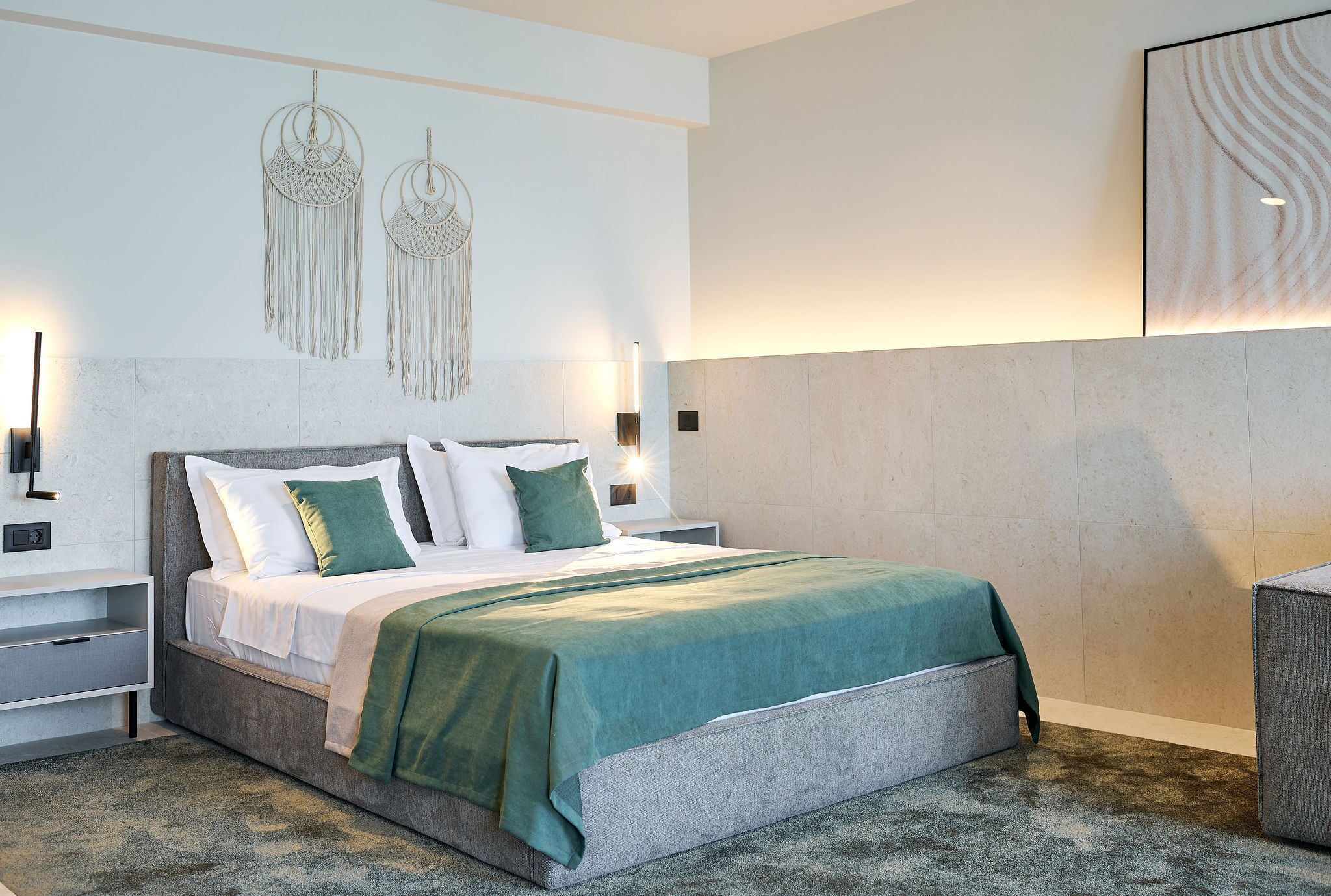 A modern bedroom with a large bed, bedside tables, and wall-mounted decor.