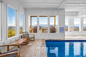 Relax by the serene pool with a breathtaking view of the surrounding mountains.