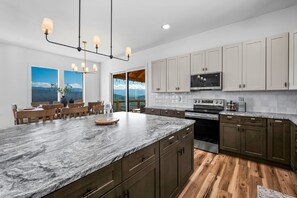 Enjoy cooking in this well-equipped kitchen with a large island, oven, and microwave.