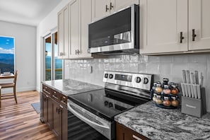 Enjoy cooking in this well-equipped kitchen with an oven, stovetop, and range hood.