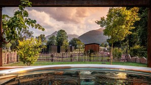A hot tub with a view of mountains and trees.