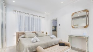 A modern bedroom with a large bed, a glass desk, and a mirror. - Sara in Ka Telir With 5 Bedrooms and 5 Bathrooms (Kastelir-Labinci)