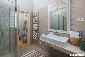 A bathroom with a large mirror, a sink, and a shower area. - Elli in Ladi i With 4 Bedrooms and 4 Bathrooms (Kanfanar)