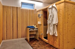 A sauna room with wooden walls, a wooden bench, and a towel rack. - Soul Sisters in Kor ula (Korčula)