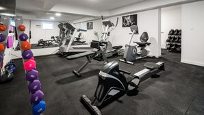 A gym with various exercise equipment, including treadmills, stationary bikes, and dumbbells. - Acadia C in Slatine With 6 Bedrooms and 6 Bathrooms (Split)