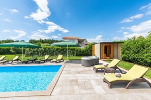 A pool area with lounge chairs and umbrellas, a hot tub, and a small wooden structure. - Fantasia in Barban With 4 Bedrooms and 2 Bathrooms (Marcana)