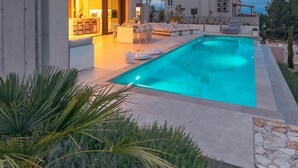 A modern building with a swimming pool, outdoor seating, and a well-maintained garden. - Loft Hvar in Hvar With 3 Bedrooms and 1 Bathrooms (Hvar)