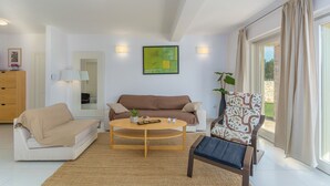 A modern living room with a sofa, armchair, and coffee table. - Seconda in Rojni i With 3 Bedrooms and 3 Bathrooms (Barban)