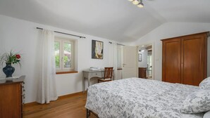 A bedroom with a large bed, a desk, and a wardrobe. - Lipa in Krnica With 4 Bedrooms and 3 Bathrooms (Marcana)