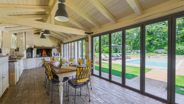 A spacious kitchen with a large window overlooking a backyard with a pool. - Lipa in Krnica With 4 Bedrooms and 3 Bathrooms (Marcana)