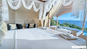 A luxurious bedroom with a large bed, a view of the sea, and a balcony with a hot tub. - Honeymoon in Murter With 1 Bedrooms and 1 Bathrooms (Tisno)