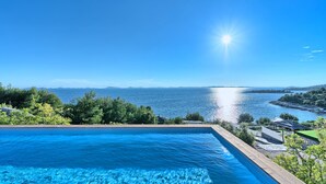 A swimming pool with a view of the sea and distant mountains. - Honeymoon in Murter With 1 Bedrooms and 1 Bathrooms (Tisno)