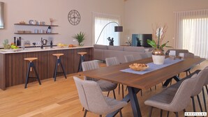 A modern kitchen with a wooden island, bar stools, and a dining area with a large table and chairs. - Vigneto in Brtonigla (Brtonigla)