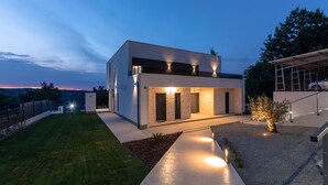 A modern two-story house with a well-maintained lawn and a driveway leading to the entrance. - Althea in Ru i i With 4 Bedrooms and 4 Bathrooms (Sveta Nedelja)