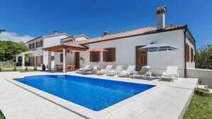 A modern house with a swimming pool, white walls, and a tiled roof. - Ana Labin in Labin With 6 Bedrooms and 1 Bathrooms (Labin)