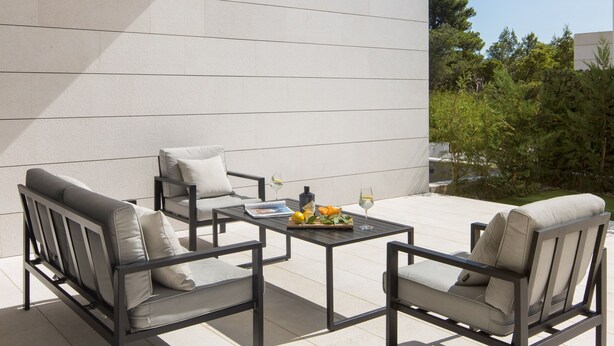 An outdoor seating area with two sofas and a table, featuring a book, fruit, and glasses. - Calma II in Starigrad (Starigrad)