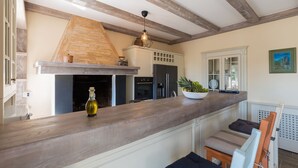 A kitchen with a wooden countertop, a built-in oven, and a hanging light fixture. - Loki in Vi Inada With 4 Bedrooms and 4 Bathrooms (Vizinada)