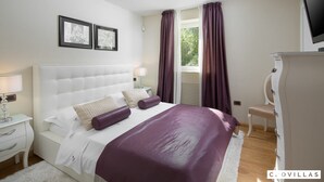 A bedroom with a large bed, a nightstand, a dresser, and a television. - Vlastelini I in Labin (Labin)