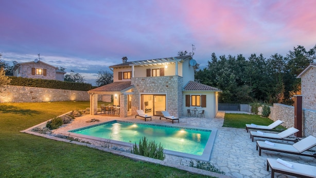 A two-story house with a swimming pool, outdoor seating, and a stone patio. - Kvarta in Barban With 3 Bedrooms and 3 Bathrooms (Barban)