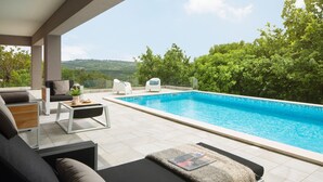 A modern outdoor pool area with a sofa, chairs, and a table. - Arsia in Labin With 4 Bedrooms and 4 Bathrooms (Rasa)