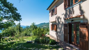 A two-story house with a garden, stone pathway, and wooden shutters. - Marina Opatija in Opatija (Opatija)