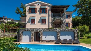 A two-story house with a stone facade, a swimming pool, and a balcony with lounge chairs. - Marina Opatija in Opatija (Opatija)
