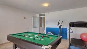 A pool table with balls, a door, and exercise equipment. - Marina Opatija in Opatija (Opatija)