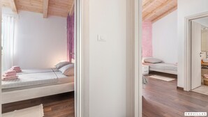 A bedroom with a bed, bedside table, and a mirror.