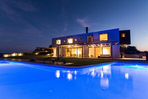 A modern house with a swimming pool at dusk. - Vista in Zamask With 3 Bedrooms and 3 Bathrooms (Pazin)