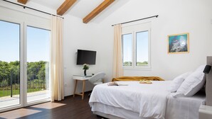 A bedroom with a bed, a desk, a TV, and large windows. - Dolce Bacio in Kavran (Marcana)