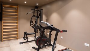 A home gym with a multi-functional exercise machine, a pull-up bar, and a treadmill. - Complex Wind Rose in Maru i i (Omis)