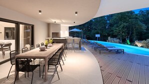 A modern outdoor dining area with a pool and a slide. - Viktor in Kr an With 7 Bedrooms and 7 Bathrooms (Krsan)