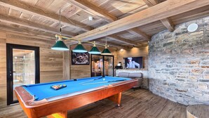 A pool table with three hanging lamps, wooden ceiling beams, and a stone wall. - Vita in Muter With 6 Bedrooms and 6 Bathrooms (Tisno)