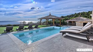 A swimming pool with lounge chairs, a gazebo, and a view of the sea. - Vita in Muter With 6 Bedrooms and 6 Bathrooms (Tisno)
