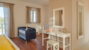 A bedroom with a bed, a dresser, a vanity with a mirror, and a window with curtains. - Stella Hvar in Rudina Hvar (Stari Grad)