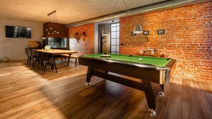 A pool table in a room with a brick wall and wooden flooring. - Aria in Vi Njan With 5 Bedrooms and 4 Bathrooms (Visnjan)